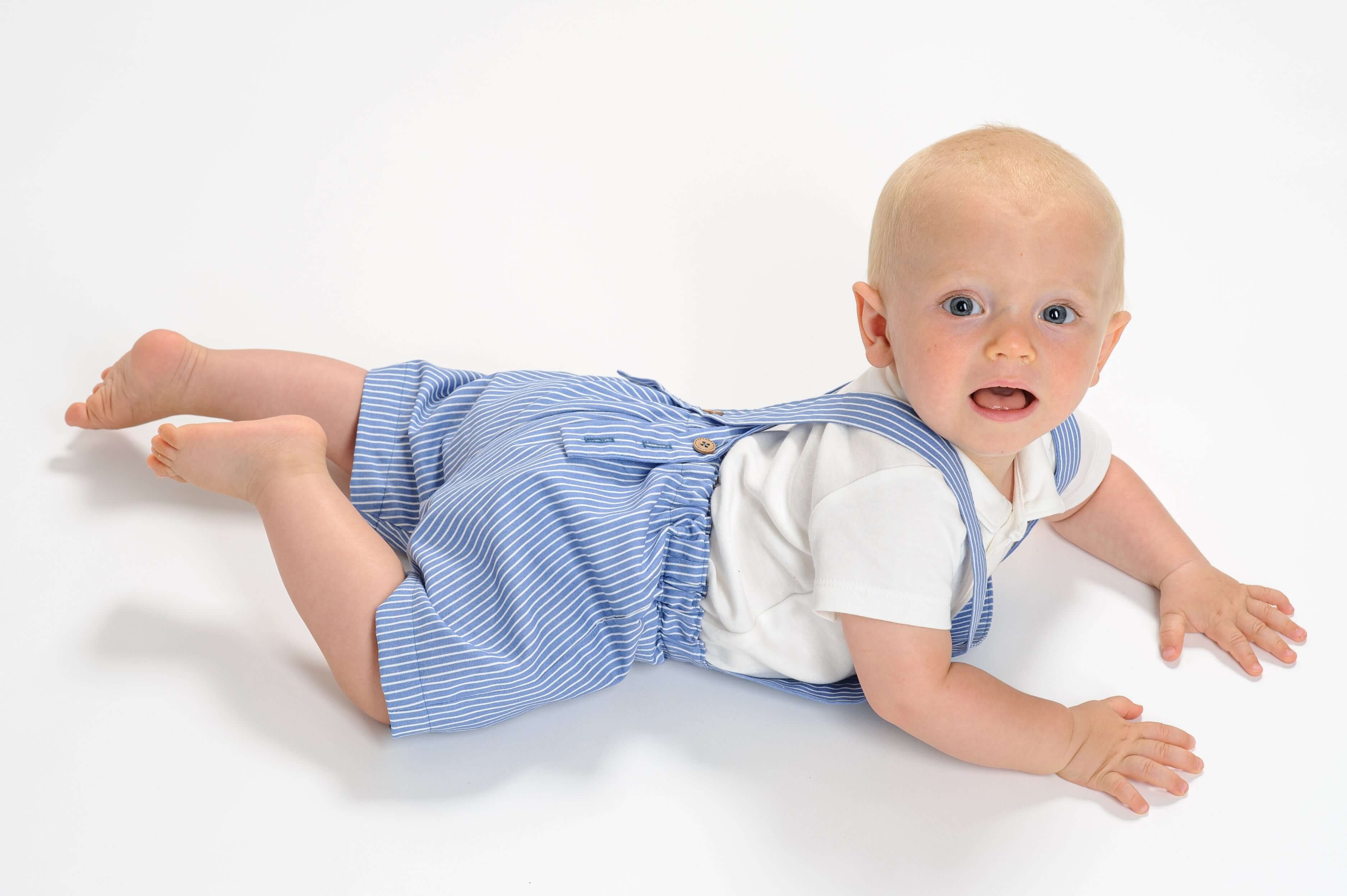 Schnittmuster Latzhose MAX PDF für Babys in blau-weiß gestreift, ideal für aktives Spielen im Sommer.