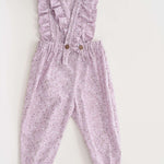Schnittmuster Latzhose DAISY in zartem Lila mit Rüschen und elastischem Bund, ideal für Kinder von 6 Monaten bis 7 Jahren.