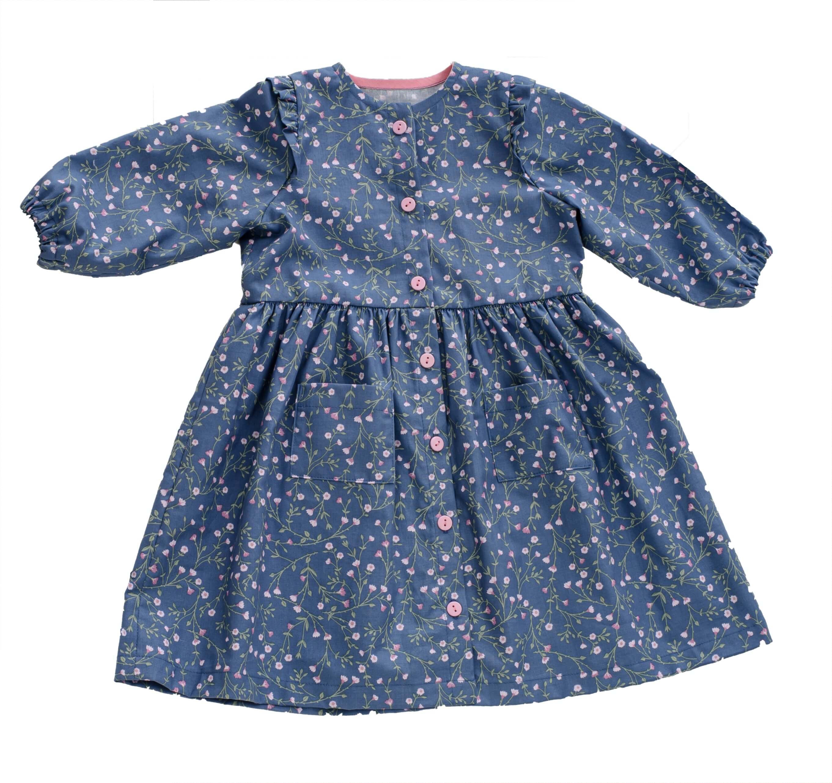 Schnittmuster Kleid MIMI PDF 2-in-1 for girls in blue floral fabric, long sleeves and button-down design.
